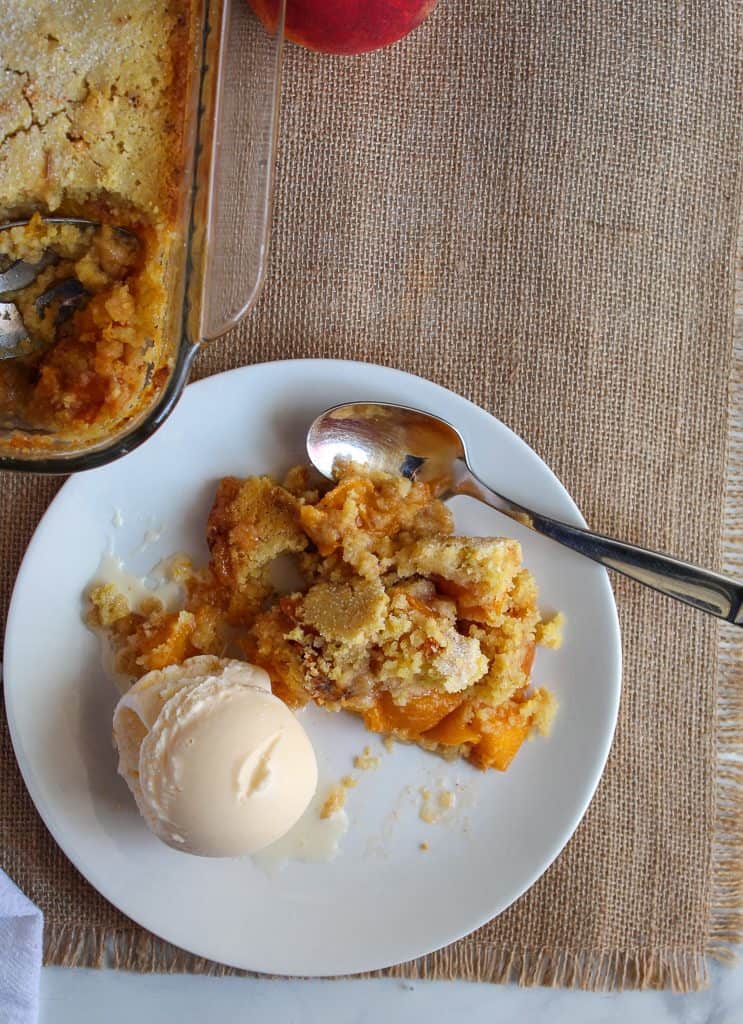 gluten free peach cobbler on a white serving plate.