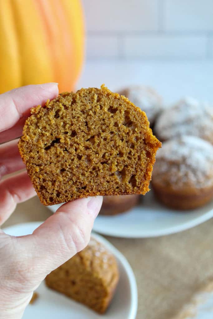 hand holding a pumpkin muffin.