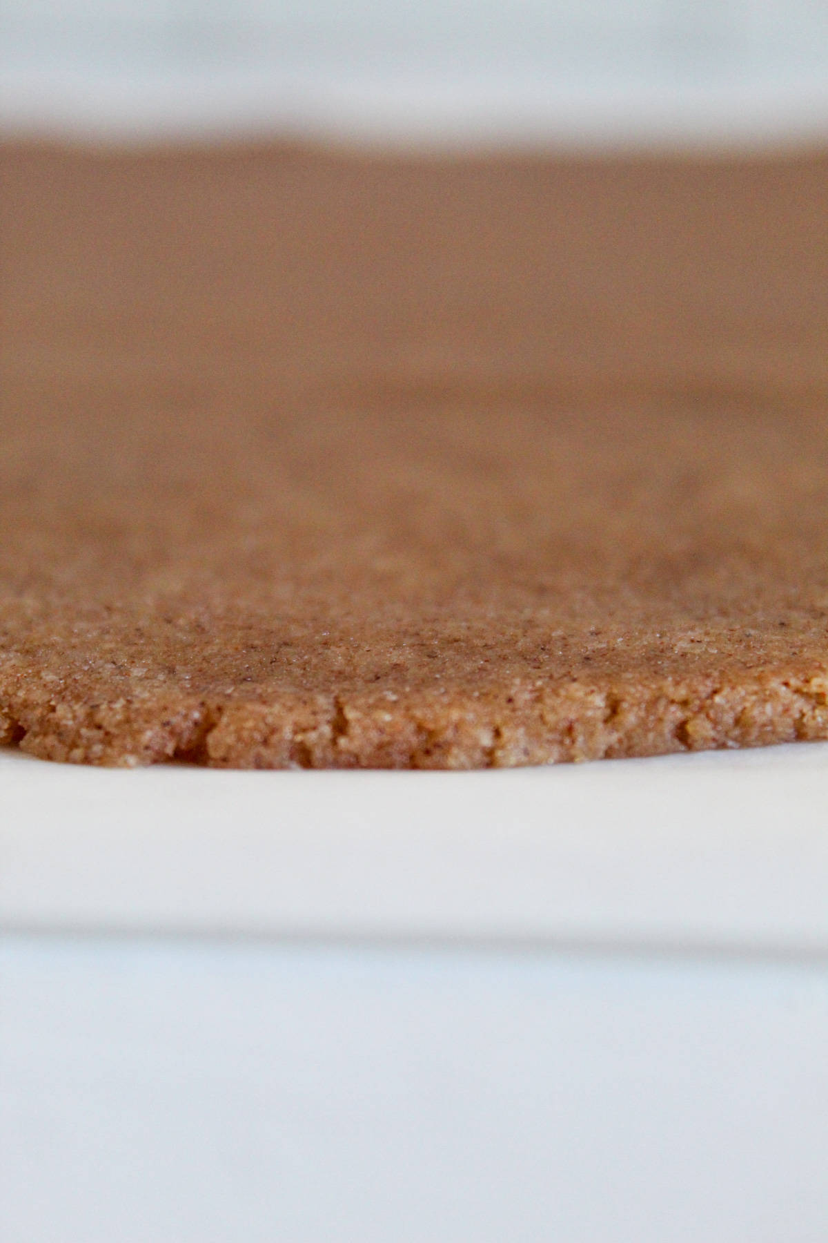 rolling graham cracker dough on parchment