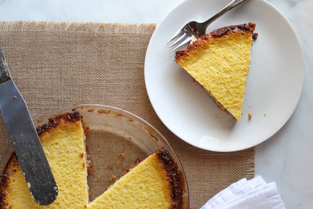 slice of gluten free buttermilk pie on a white plate