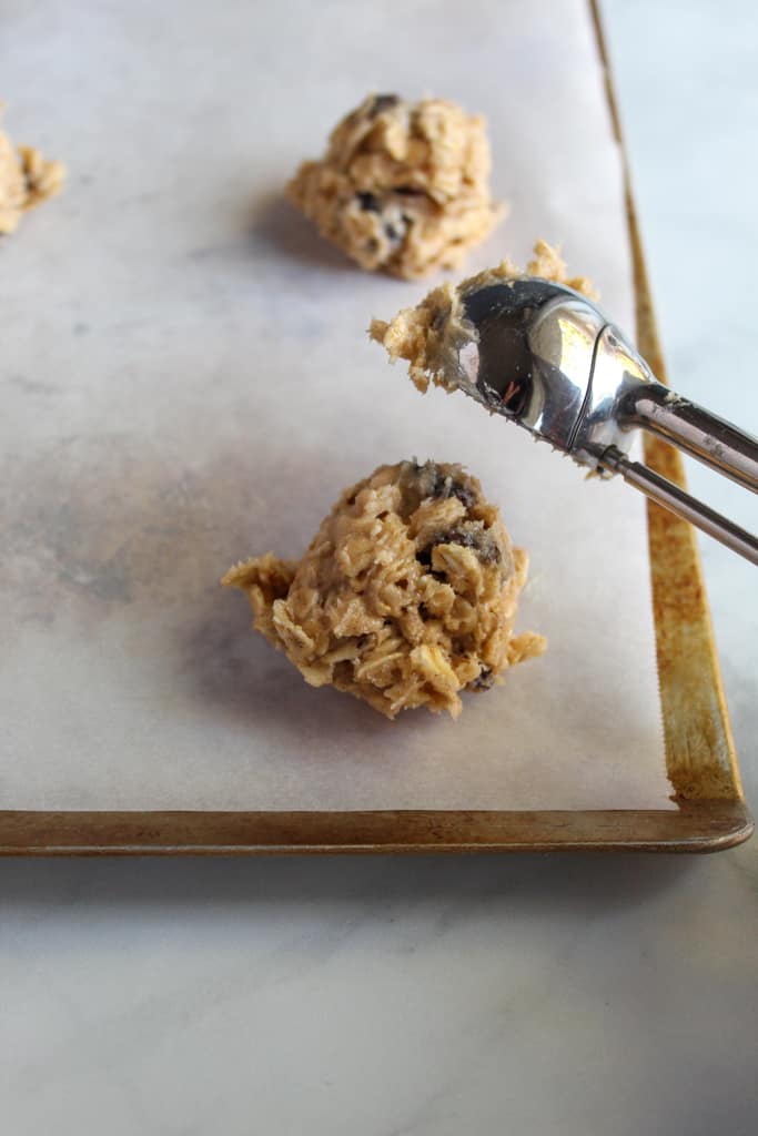 gluten free oatmeal raisin cookies portioned on a cookie sheet