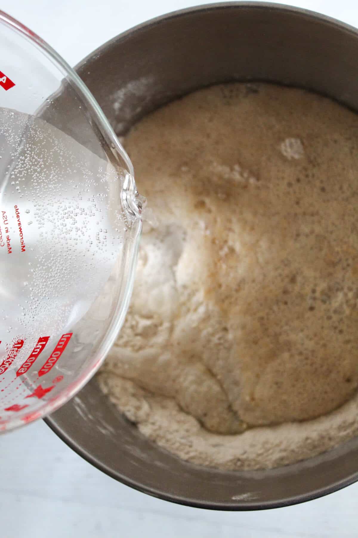 adding liquid to dry ingredients.