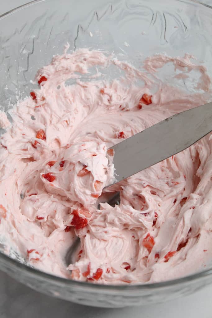 gluten free strawberry cake frosting on a speader