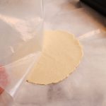 peeling wax paper off a cassava flour tortilla