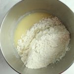 gluten free potato rolls flour added to a mixing bowl