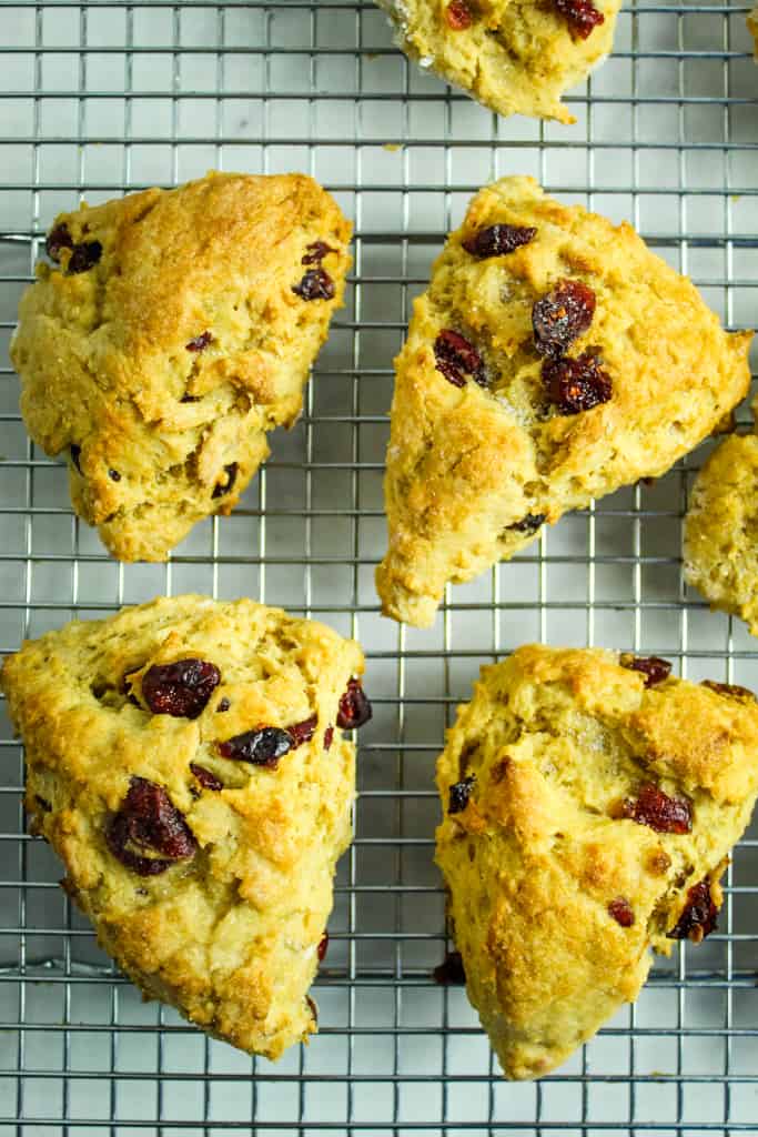 baked gluten free cranberry orange scones sitting on a wire rack