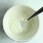 gluten free icing in white bowl with spoon