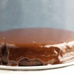 shot of chocolate ganache dripping don a cake