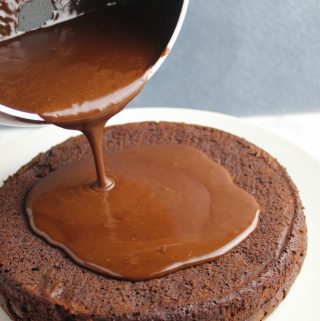 pouring dairy free chocolate ganache on cake