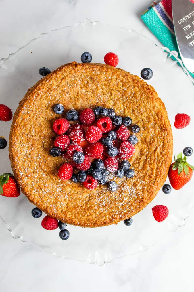 overhead shot of flourless vanilla cake with fresh berries on top