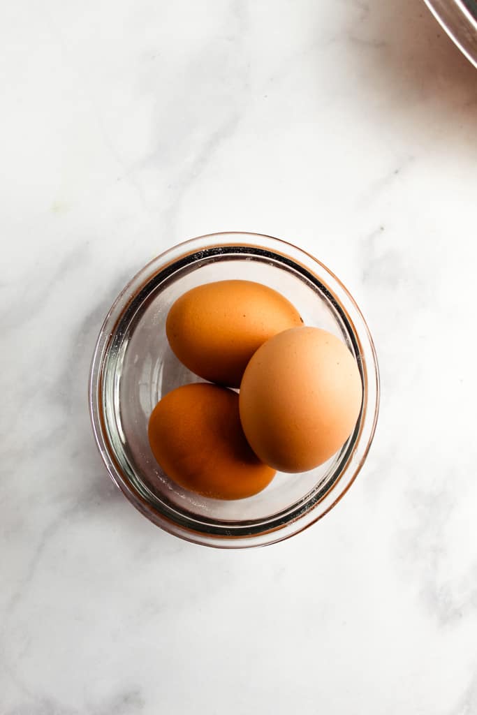 3 eggs in a glass bowl