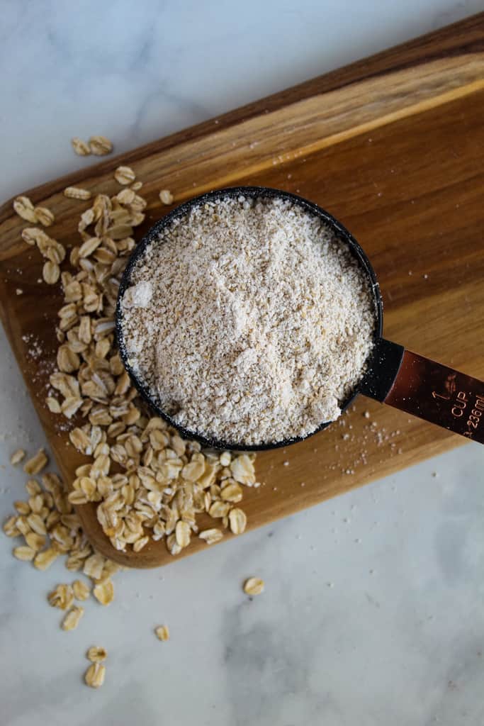 overhead shot of oat flour in a cup