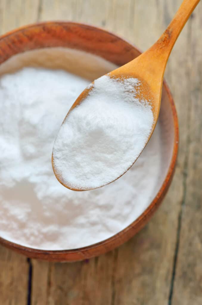up close overhead shot of baking powder on a spoon