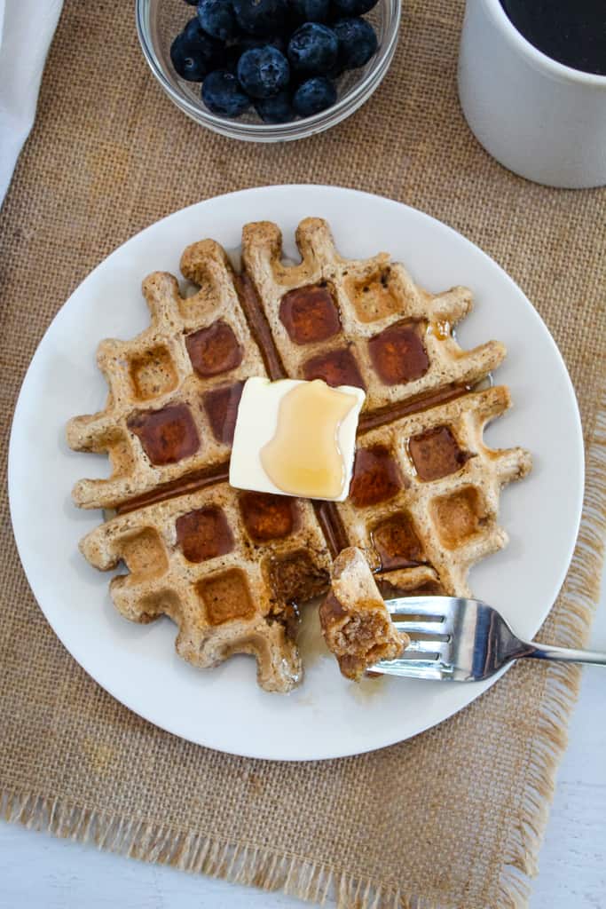 plate of waffles on a beige tablecloth