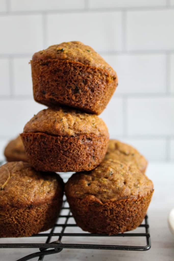stacked zucchini muffins on a white plate