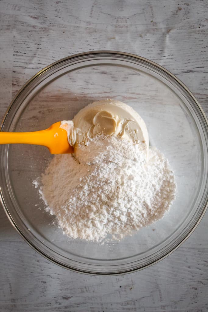 powdered suagr and cream cheese in a bowl