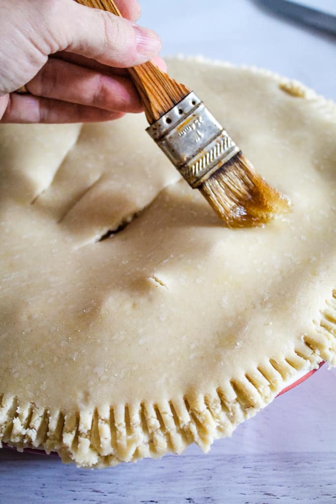 overhead shot of brushing pie with egg