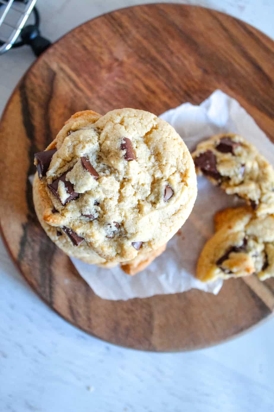 stack of Gluten-Free Dairy-Free Chocolate Chip Cookies on a brown cutting board