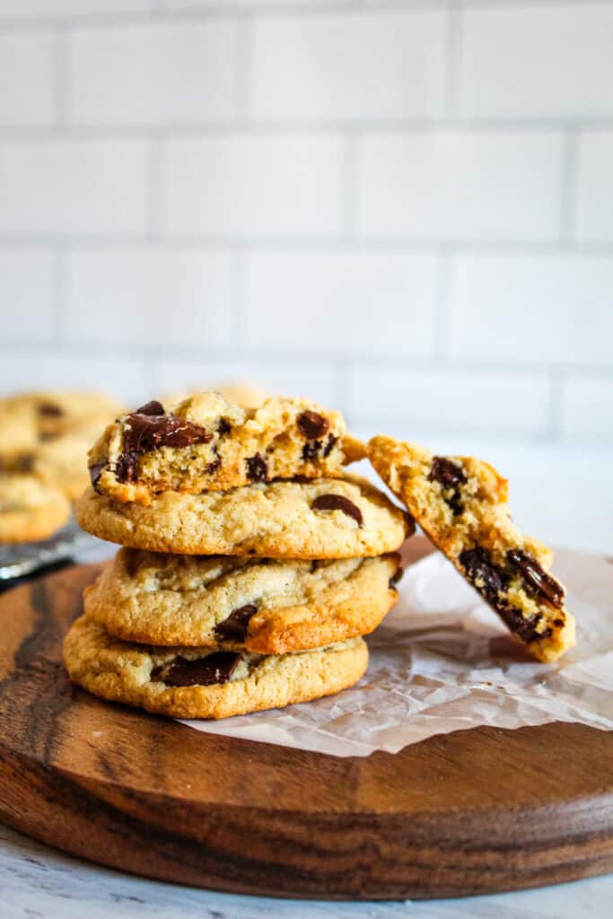 stack of chocolate chip cookies on a brown cutting board