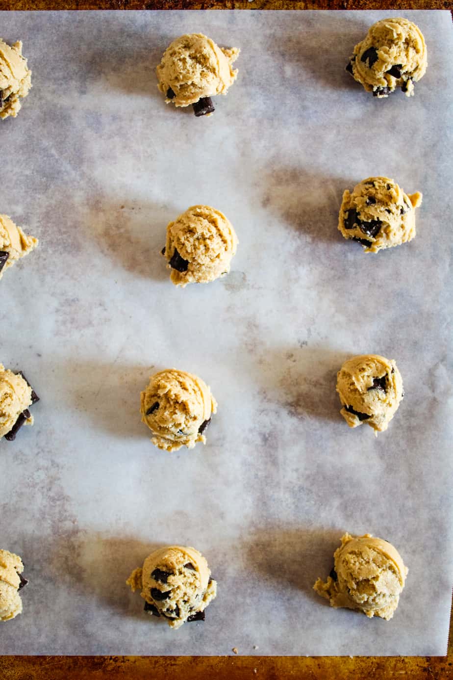 portioned Gluten-Free Dairy-Free Chocolate Chip Cookies on a baking sheet