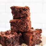 4 stacked oat flour brownies on a white plate