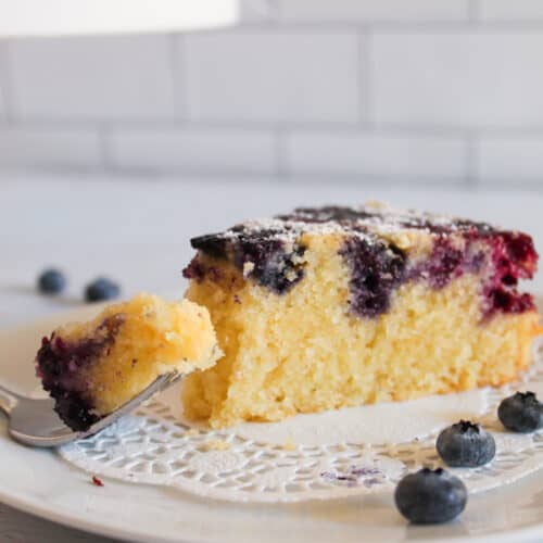 slice of blueberry cake with a bite