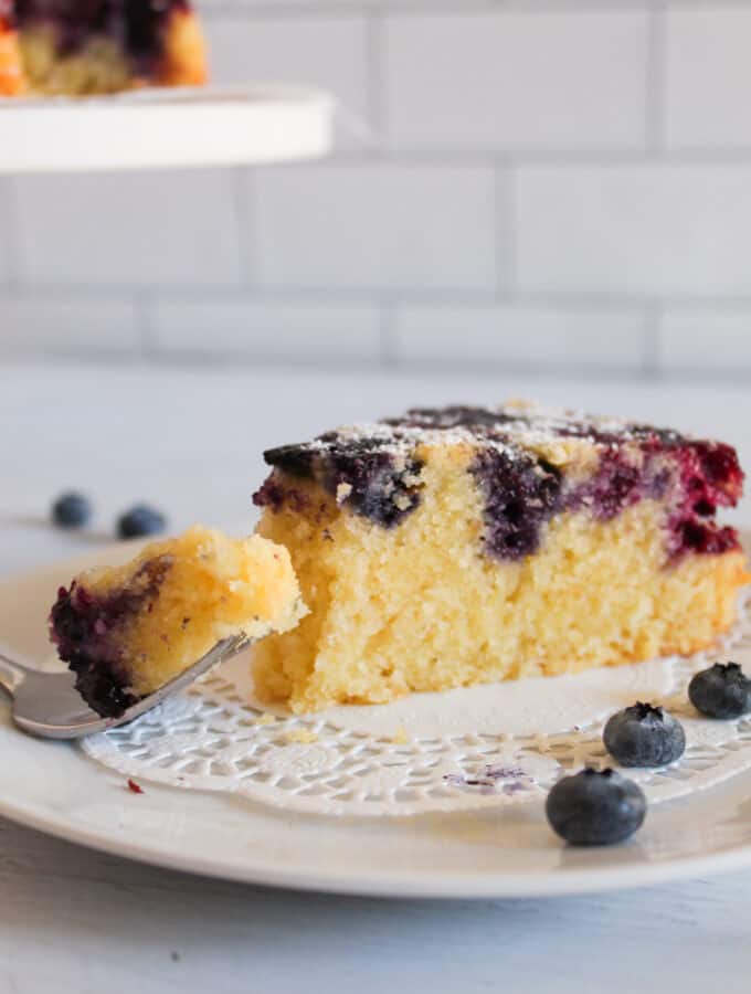 slice of blueberry cake with a bite