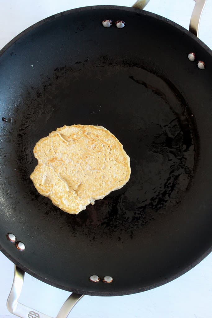 pancake cooking on a griddle.