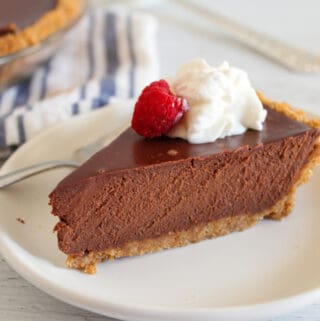 up close slice of chocolate pie on a white plate.