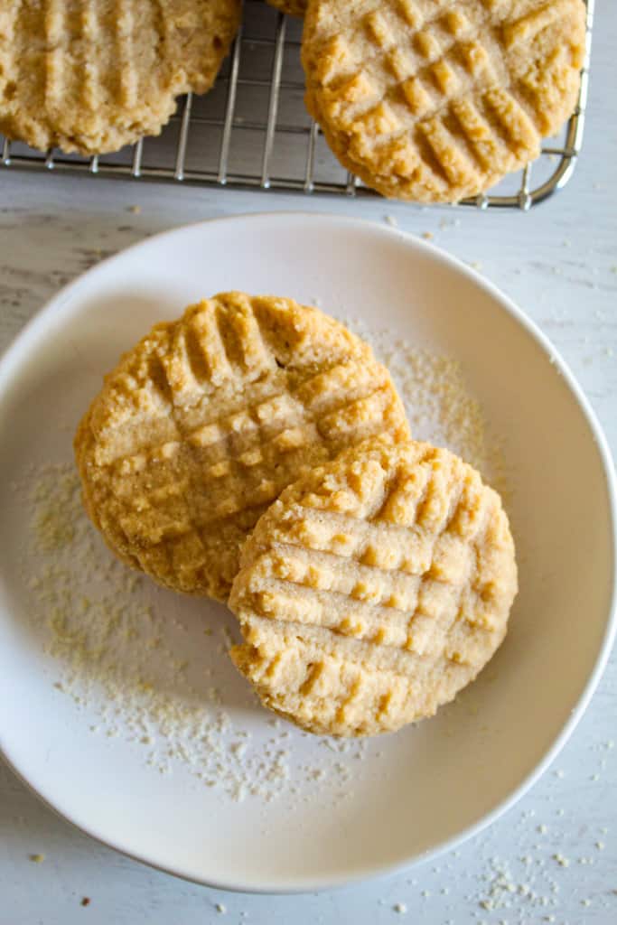 two almond flour peanut butter cookies on a plate.