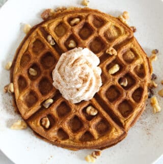 overhead shot of waffle on a white plate.