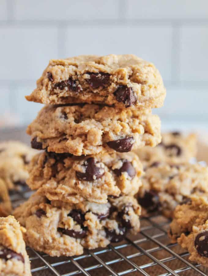 stack of oat flour chocolate chip cookies on a wire rack.