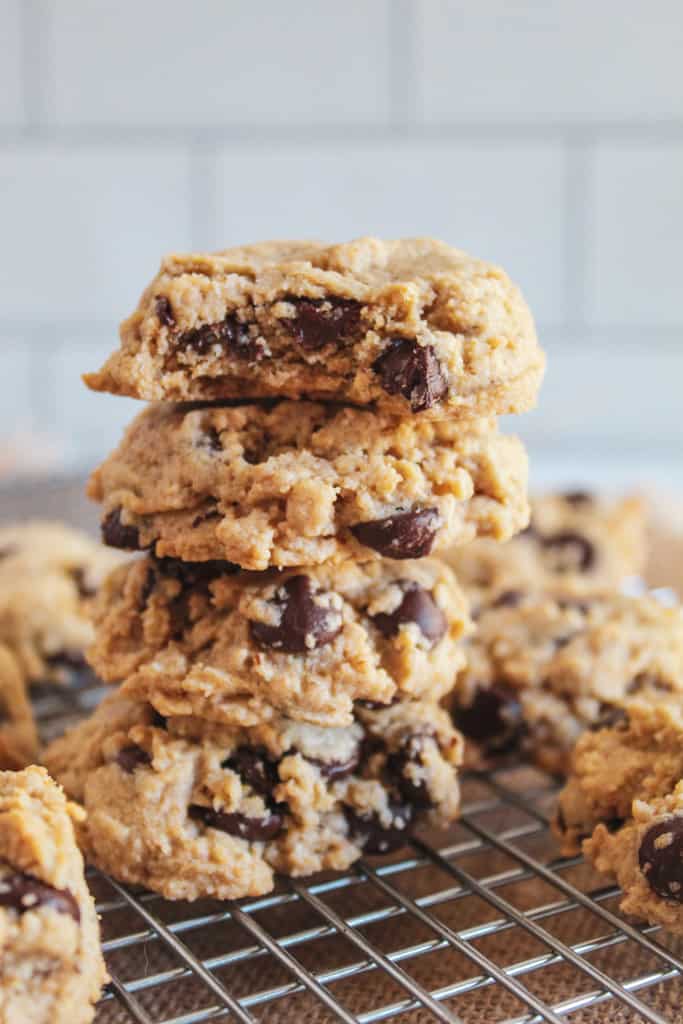 stack of oat flour chocolate chip cookies on a wire rack.