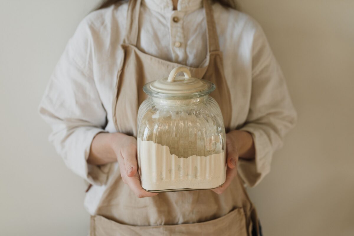woman holding jar of flour