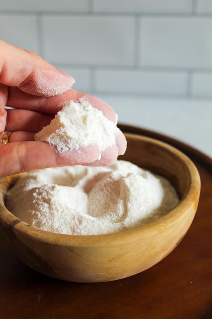 brown bowl of sweet rice flour with a hand holding.