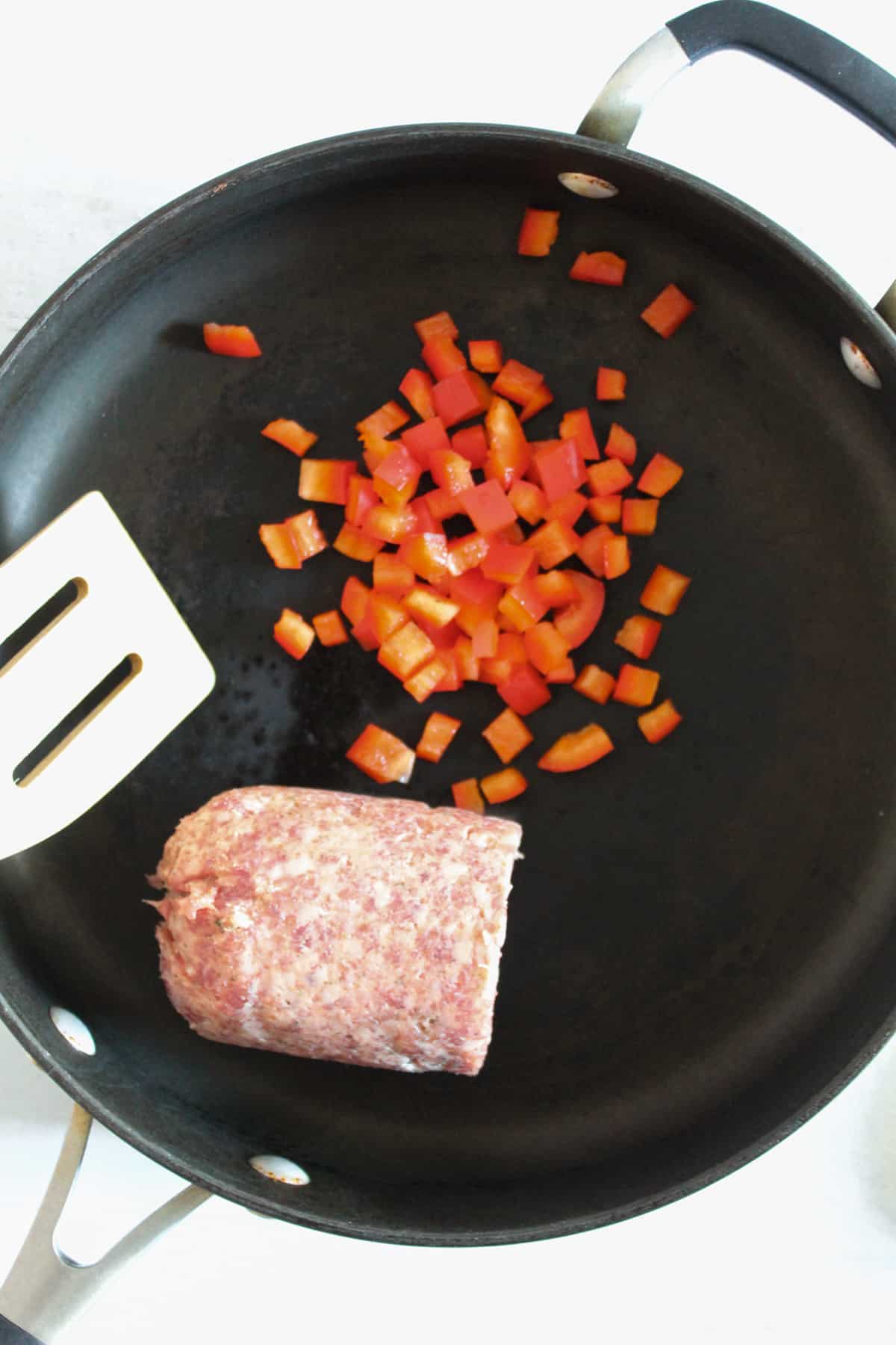 sausage and red pepper in a skillet