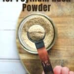 hand holding teaspoon of psyllium husk powder
