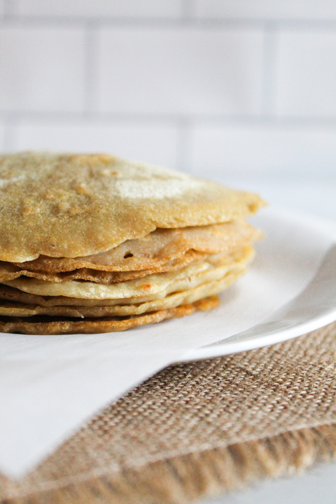 buckwheat crepes stacked on a plate.