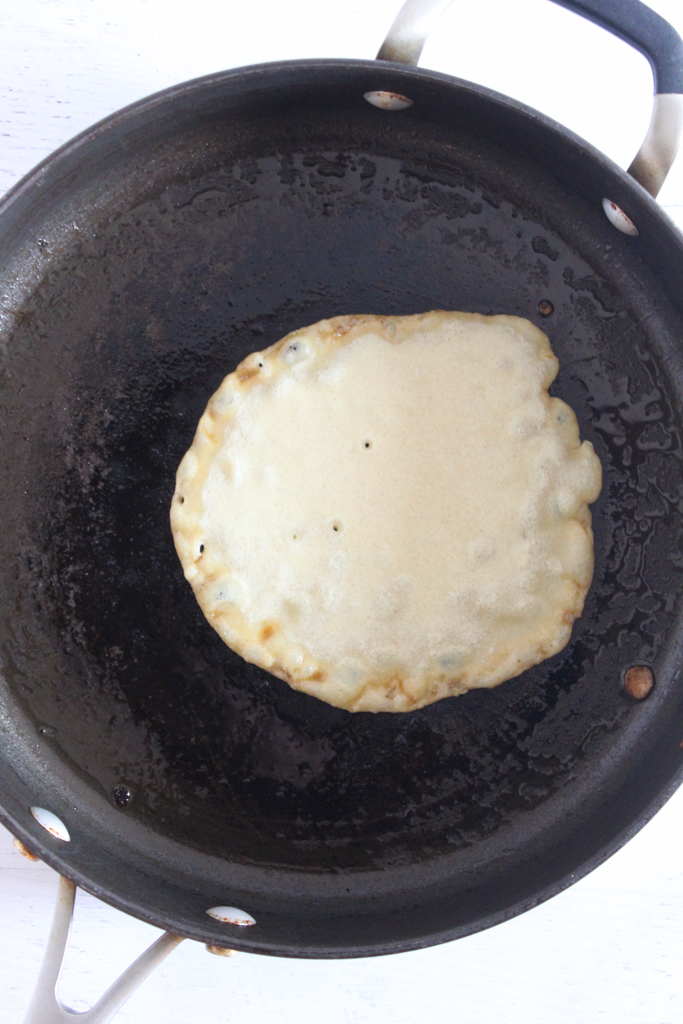 buckwheat crepes cooking in a skillet.