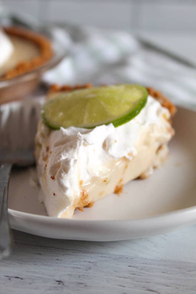 slice of gluten free key lime pie on a white plate.