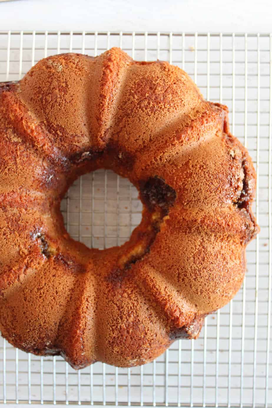 baked gluten-free King cake on a wire rack.