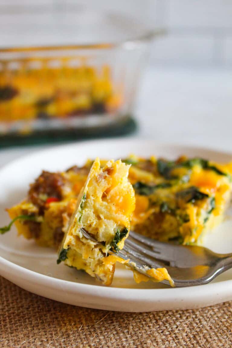 bite of sausage egg casserole on a fork.