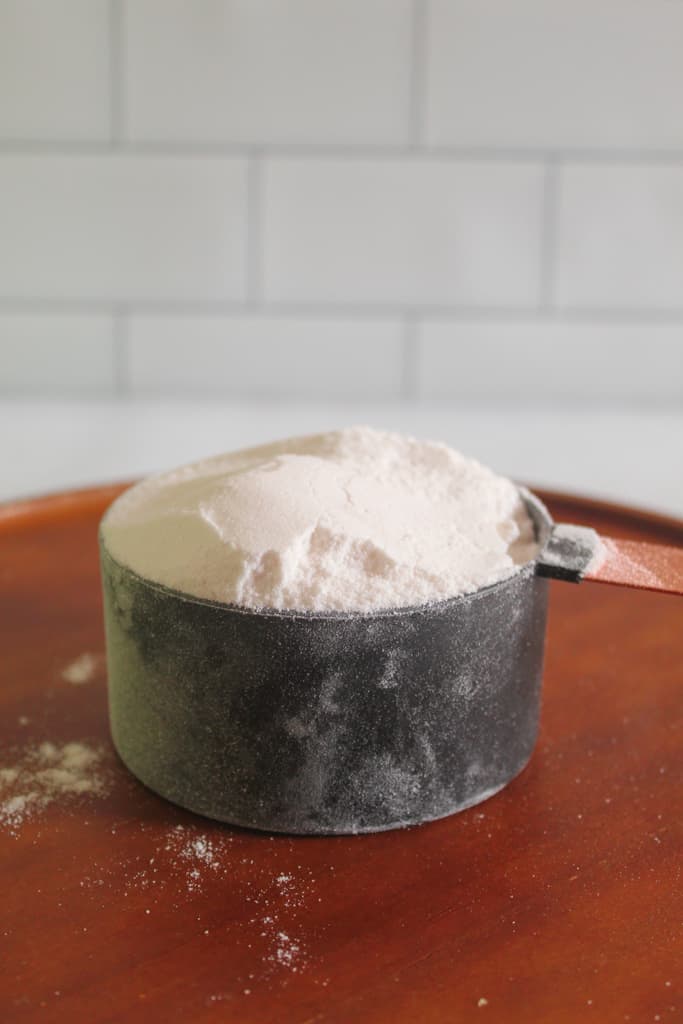 cup of flour on a cutting board.