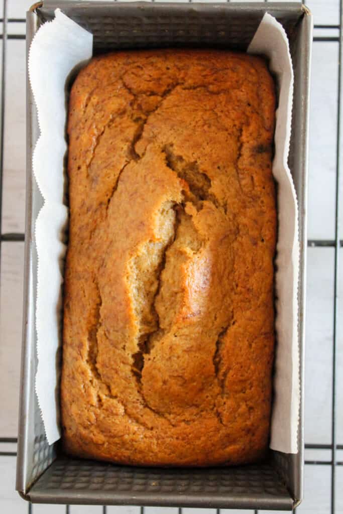 loaf of oat flour banana bread in a pan.