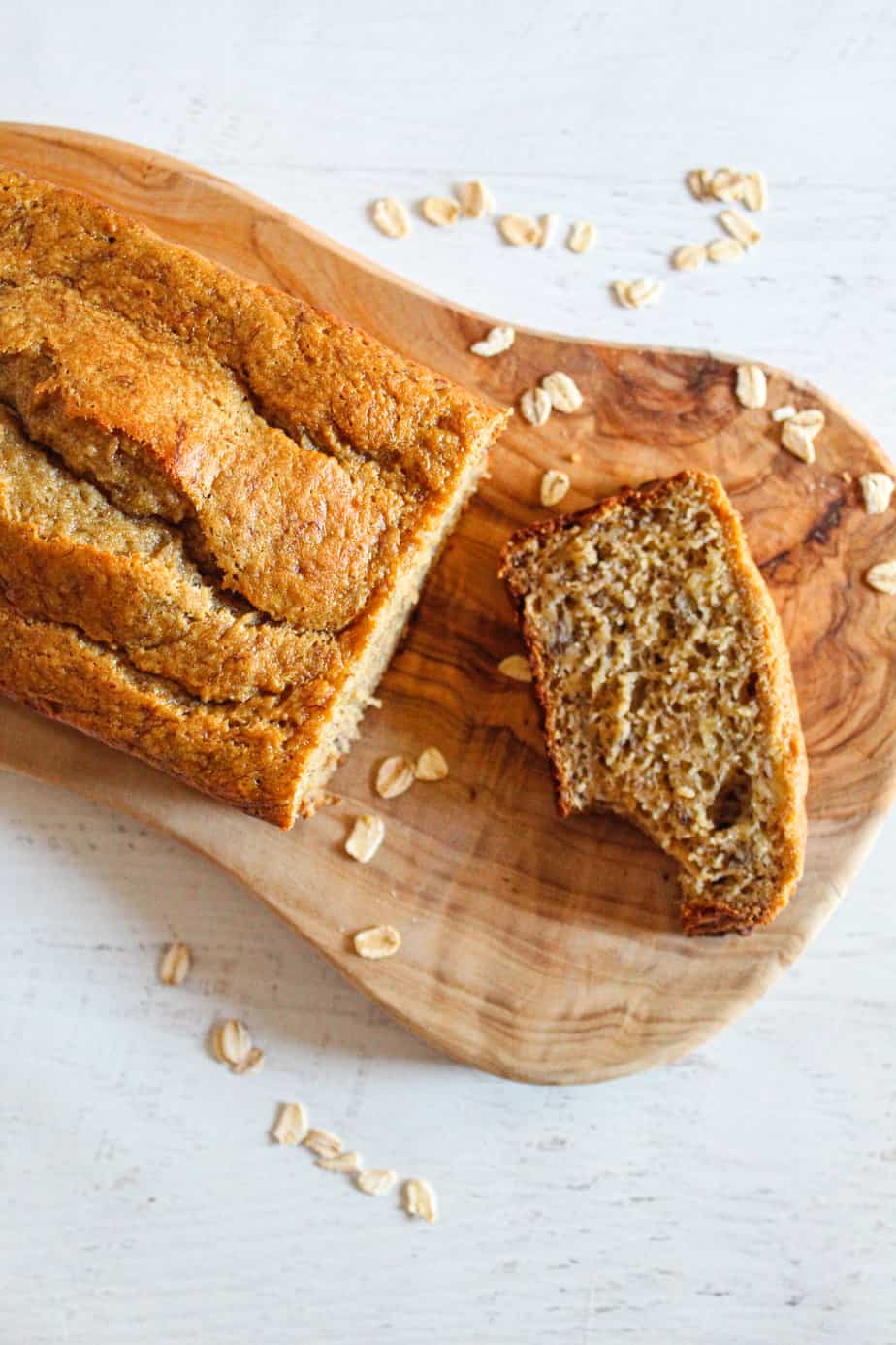 slice of oat flour banana bread on a cutting board.