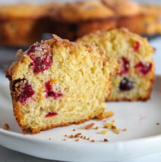 inside of a cranberry orange muffin on a white plate.