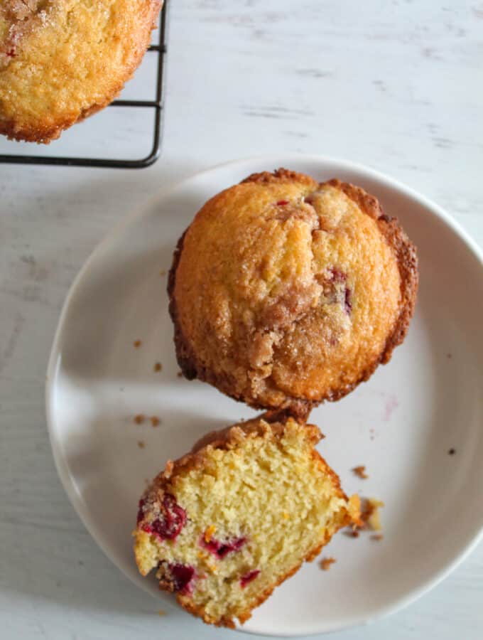 cranberry orange muffins on a white plate.