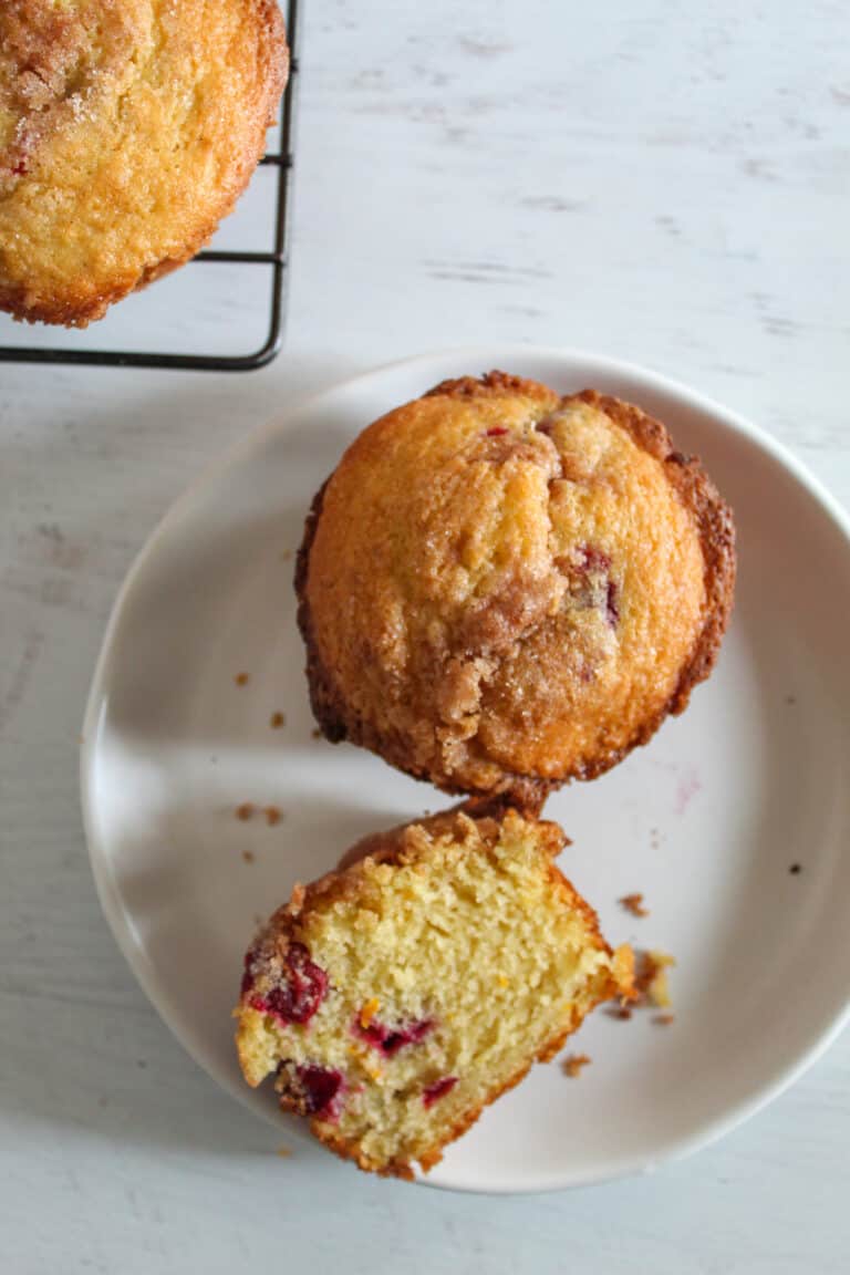 cranberry orange muffins on a white plate.