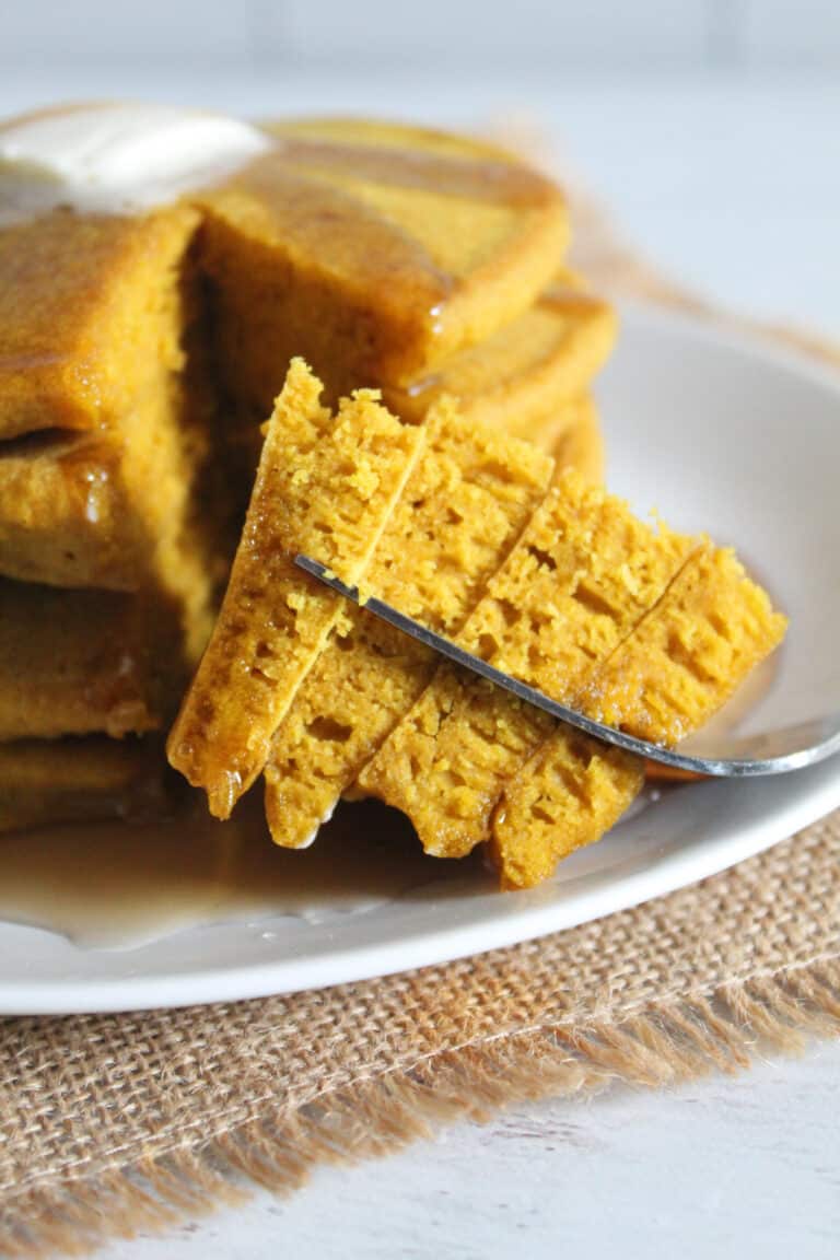 bite of buckwheat pancakes on a fork.