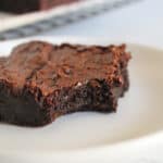 piece of flourless chocolate brownie on a plate.